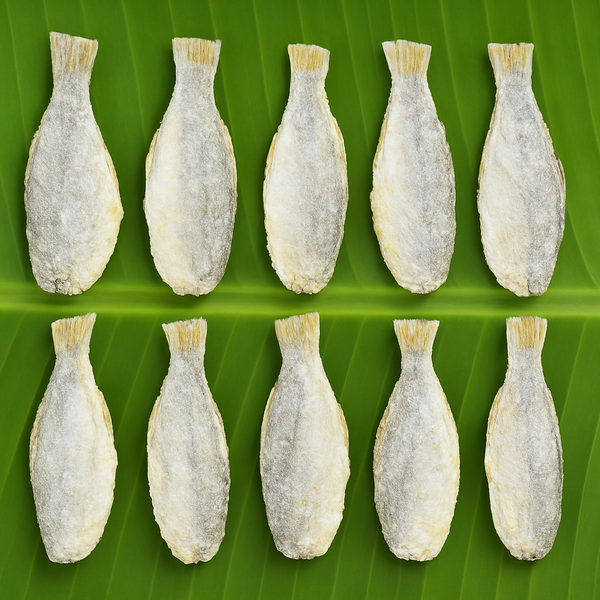 Professional product image of dried fish on banana leaf
