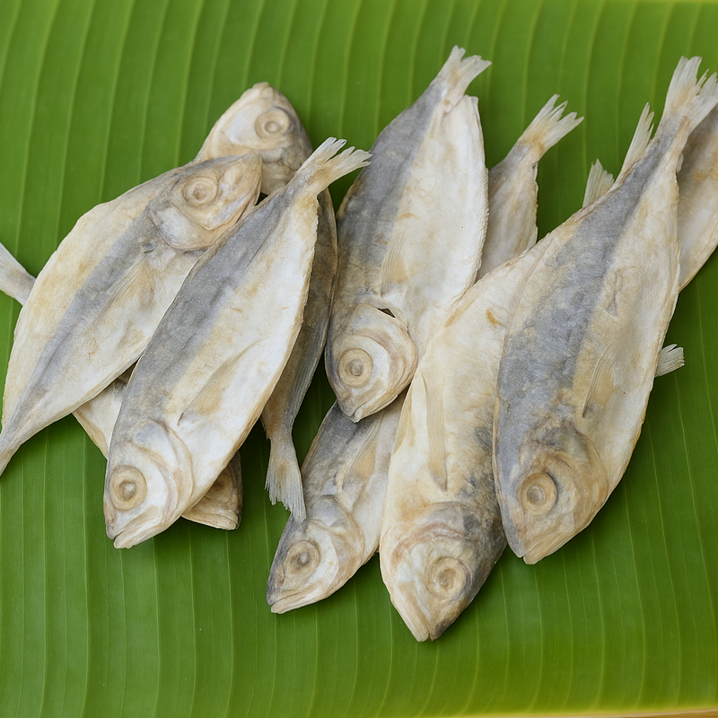 Professional product image of whole dried fish on banana leaf