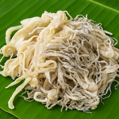 Square format dried squid on banana leaf