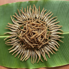 Dried fish pieces on banana leaf for Meta ads