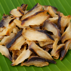 Generated dried fish flakes with brown and black shades on banana leaf
