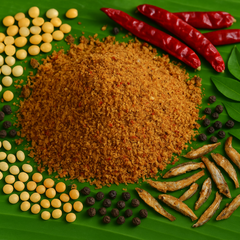 Professional product image of homemade masala with dal, spices and fried nethili on banana leaf