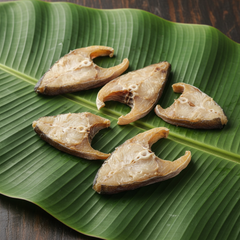 Skinless cut dried fish pieces on banana leaf for Meta ads