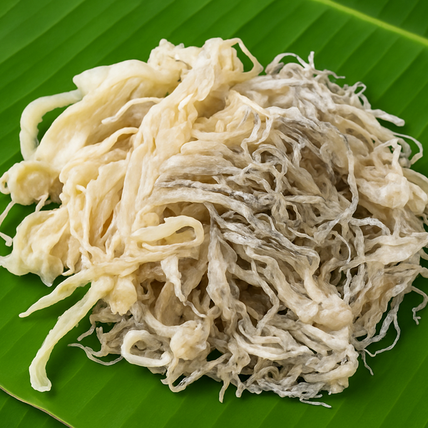 Square format dried squid on banana leaf