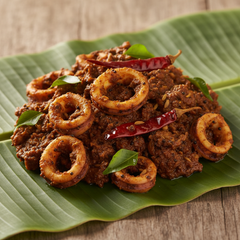 Squid Thokku Cut Pieces with Masala on Banana Leaf